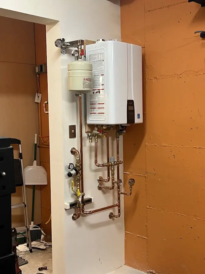 Plumbing technician inspecting water heater connections in Lithia Springs
